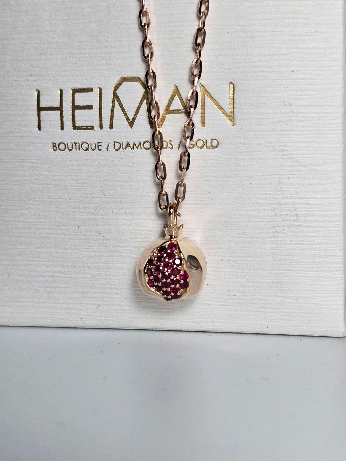 Baby pomegranate pendant 14k gold set with natural ruby's without a chain.