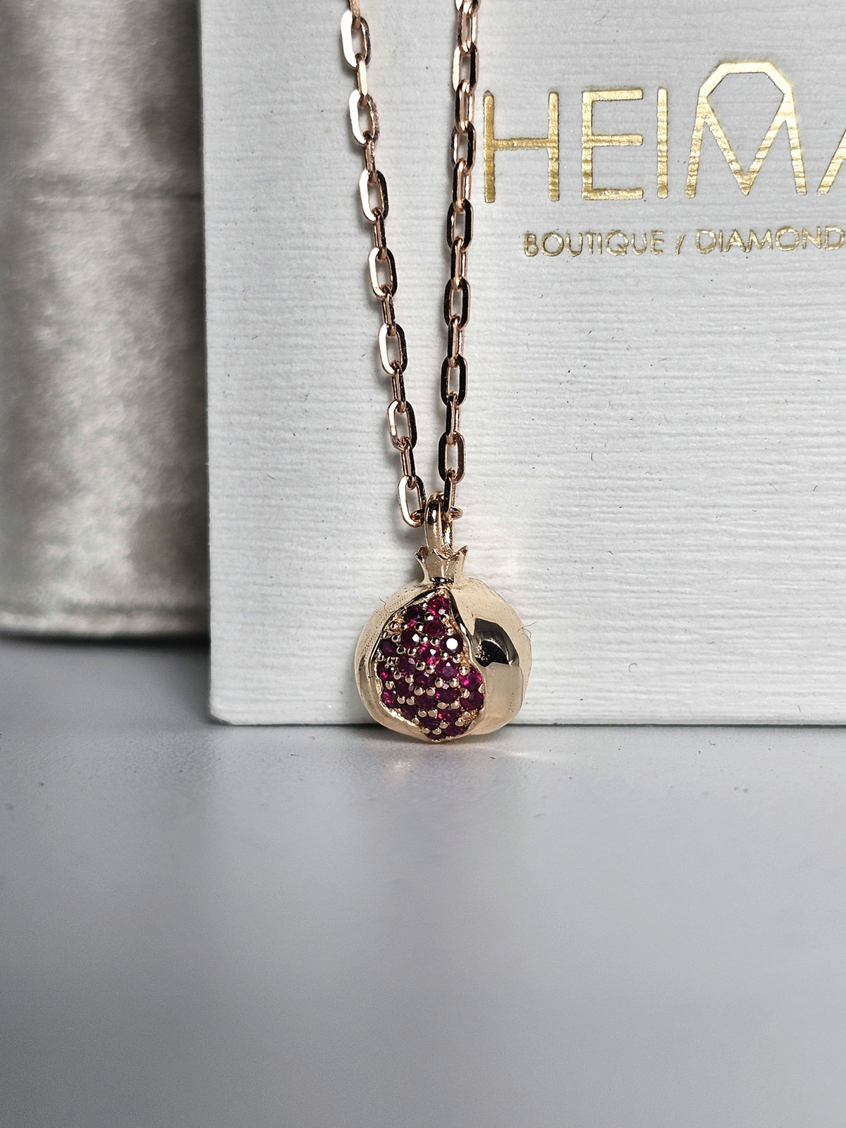 Baby pomegranate pendant 14k gold set with natural ruby's without a chain.