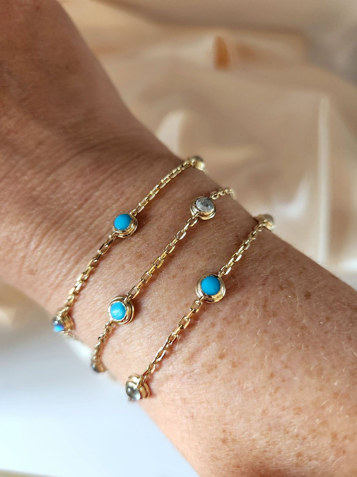 Gold eye bracelet set with natural gems.