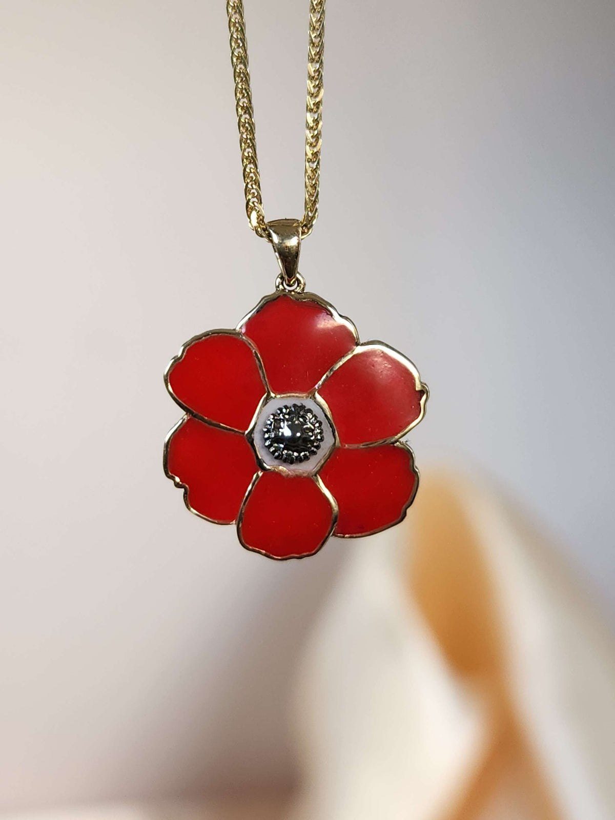 Poppyseed pendant, 14k yellow gold and enamel, comes on 14k chain.
