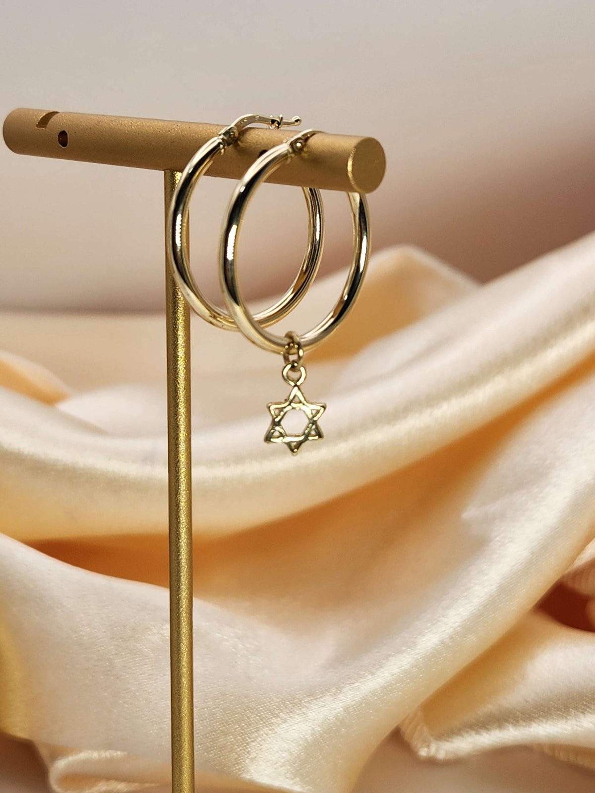 Gold hoop earrings with a Star of David