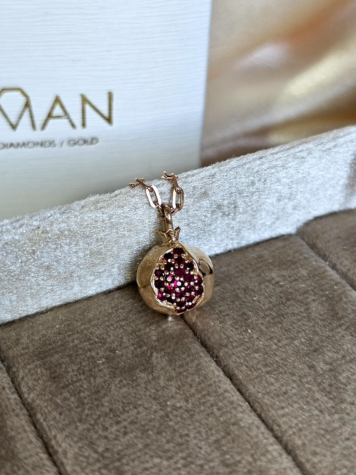 Baby pomegranate pendant 14k gold set with natural ruby's without a chain.