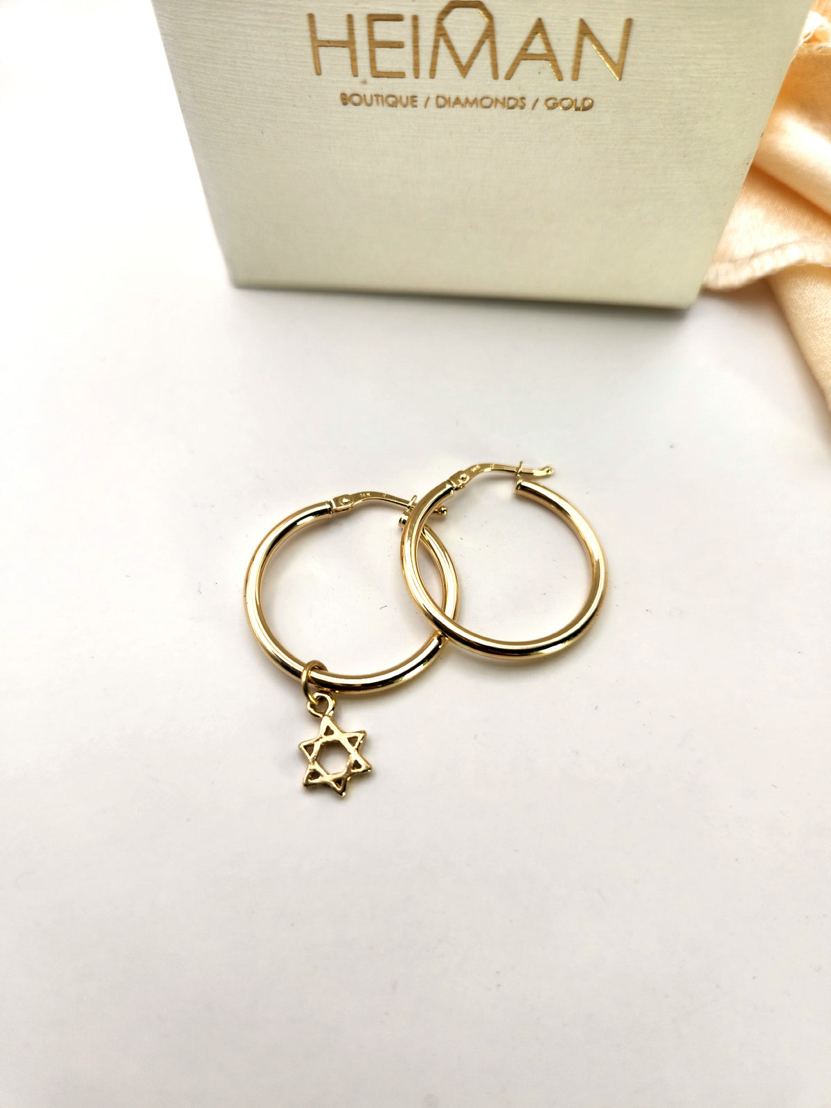 Gold hoop earrings with a Star of David