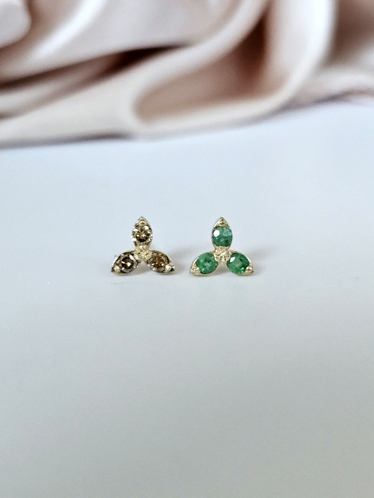 Pair of 14k gold stud three stone earrings, set with natural gems.