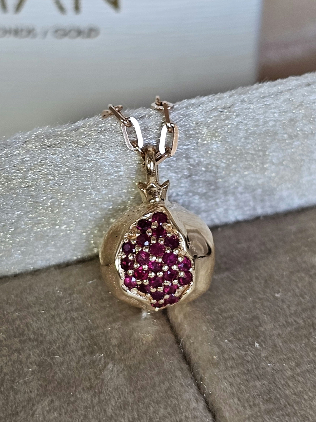 Baby pomegranate pendant 14k gold set with natural ruby's without a chain.
