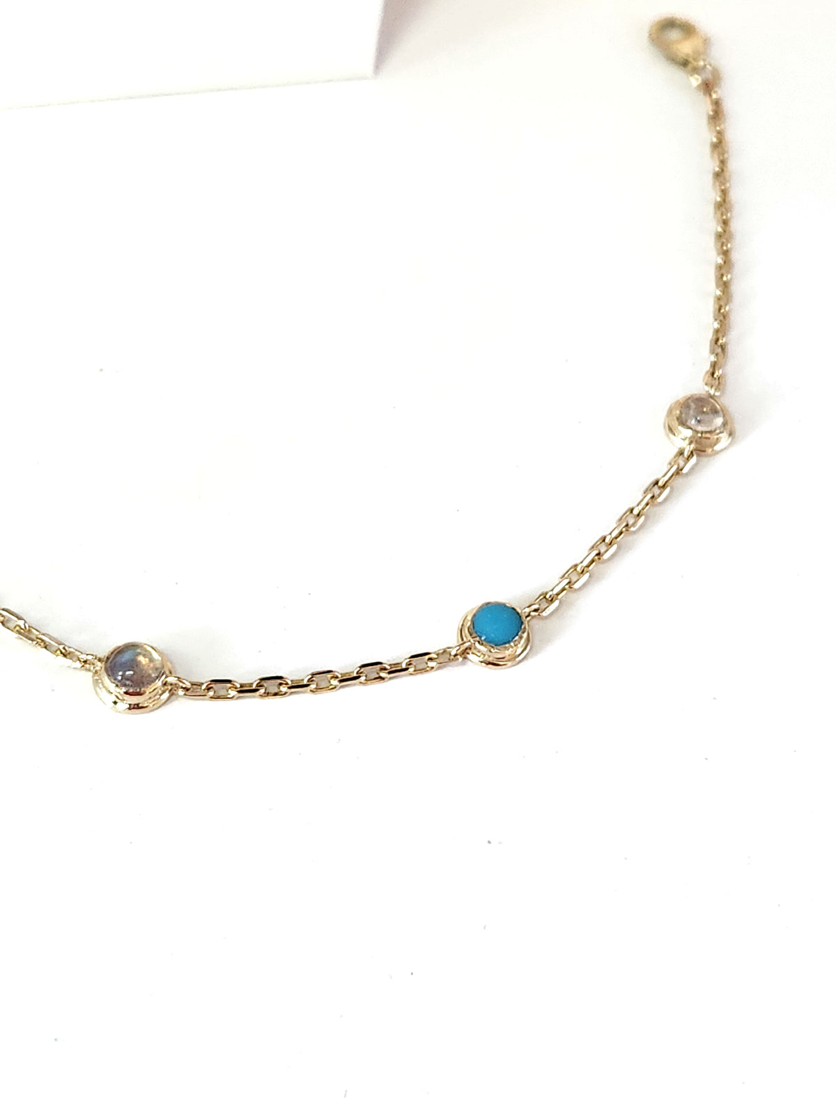 Gold eye bracelet set with natural gems.