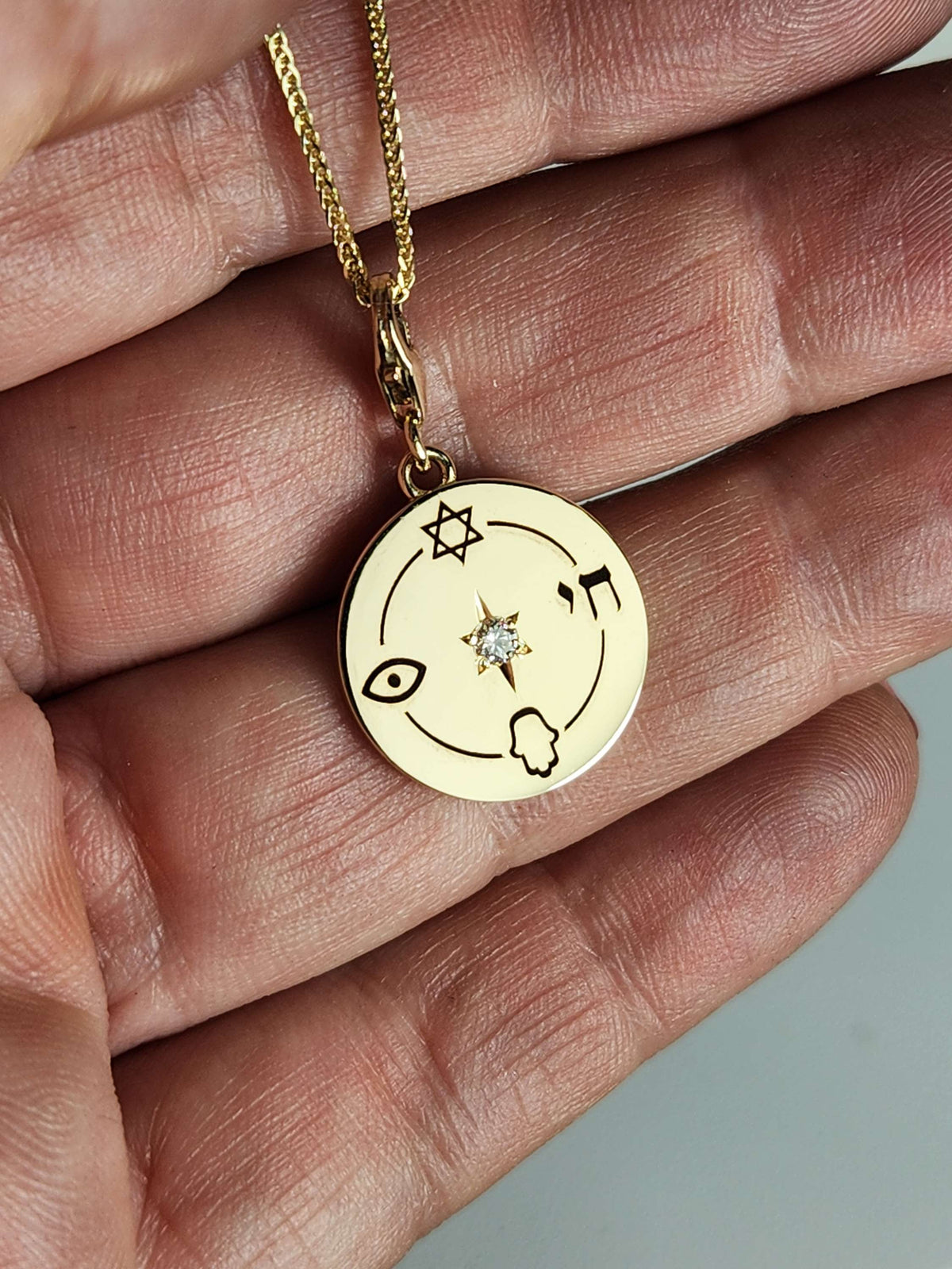Medium size "Jewish compas" necklace, 14k gold set with a natural diamond.