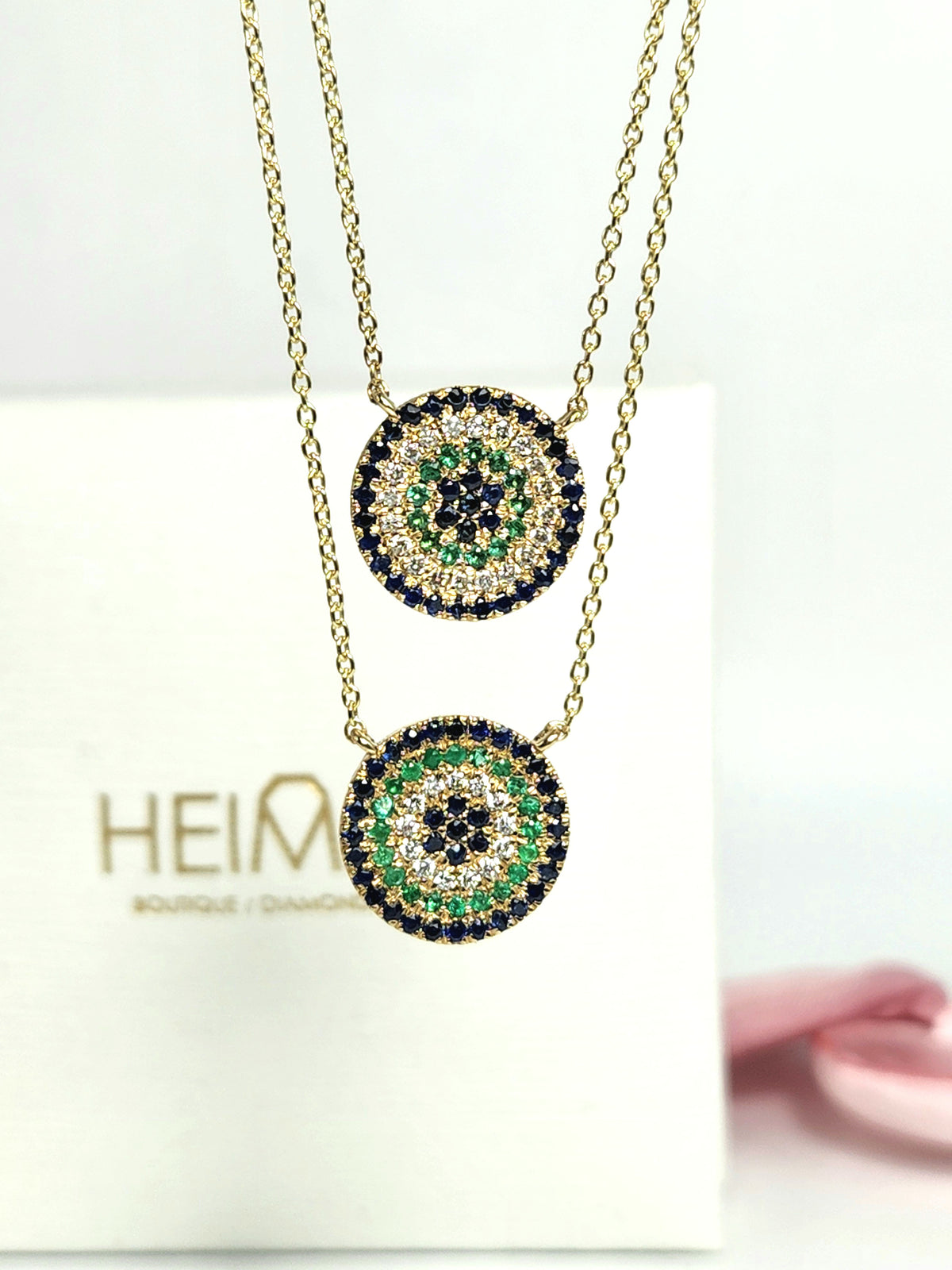 Round eye necklace 14k gold, sapphires, emeralds, and diamonds.