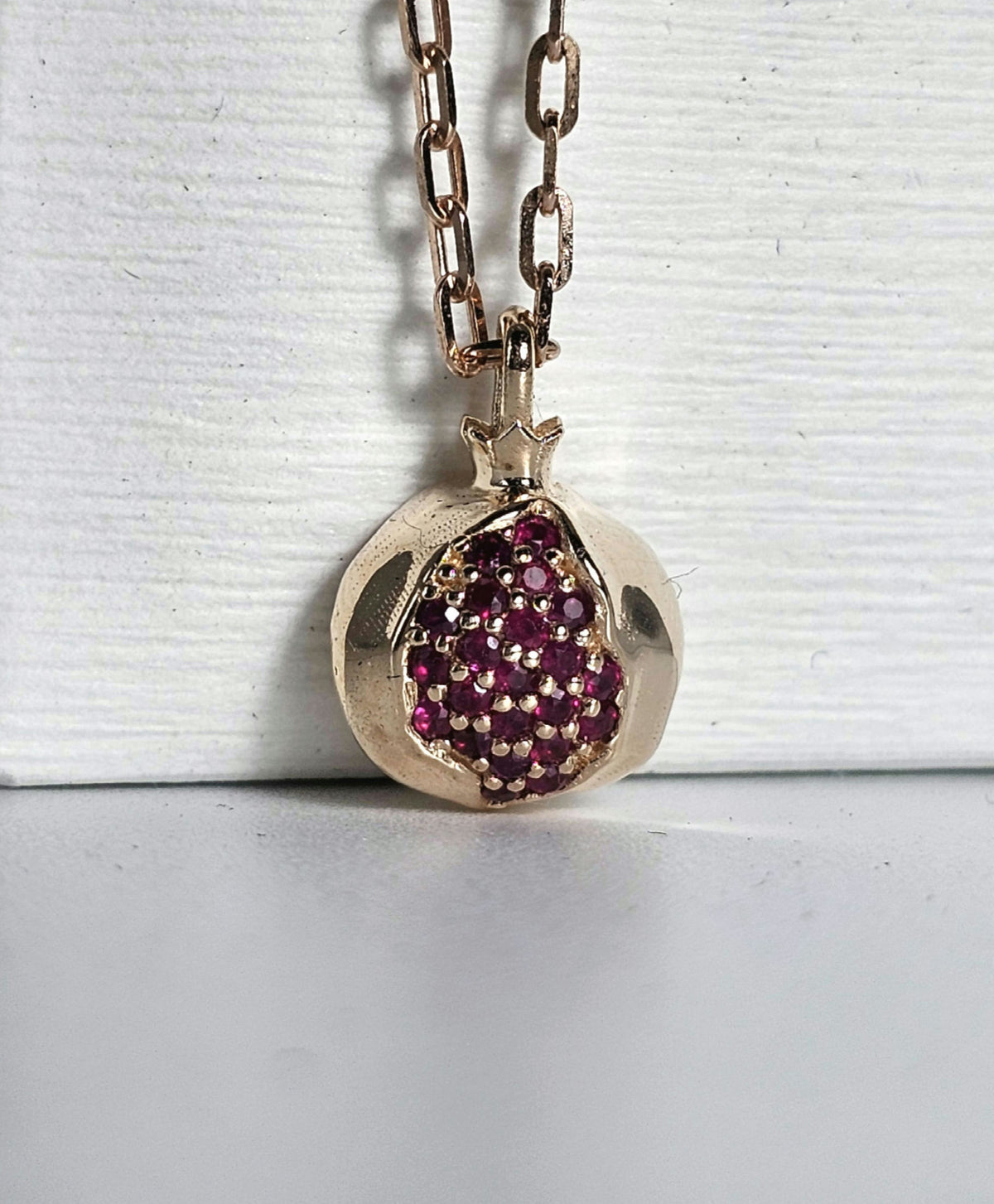 Baby pomegranate pendant 14k gold set with natural ruby's without a chain.