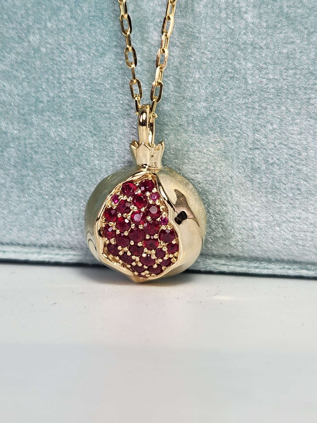 Large 20mm pomegranate in 14k gold set with natural ruby's