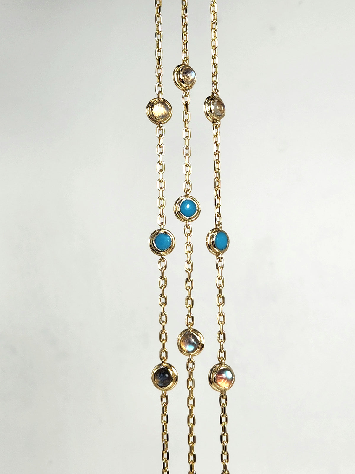 Gold eye bracelet set with natural gems.