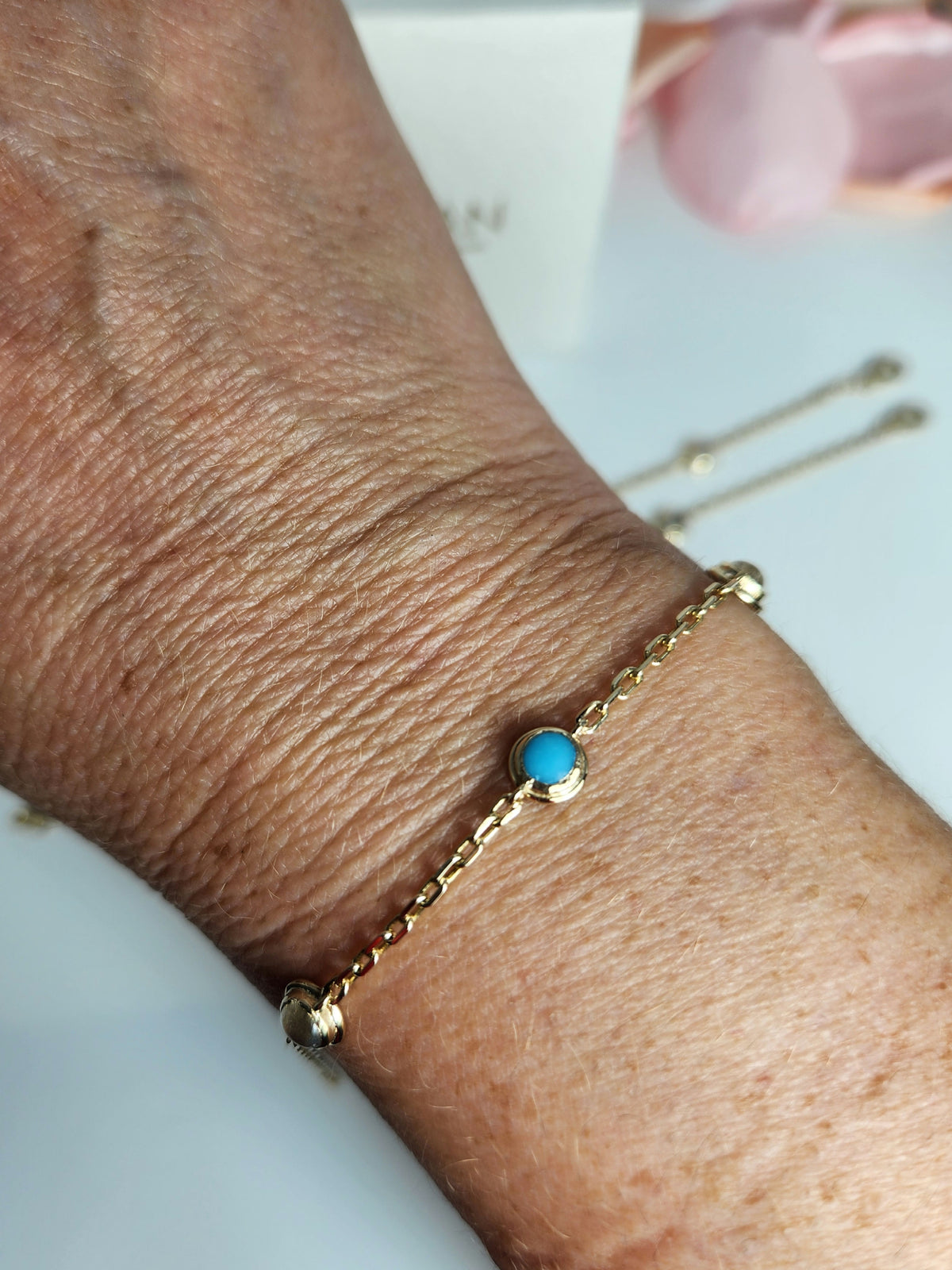 Gold eye bracelet set with natural gems.