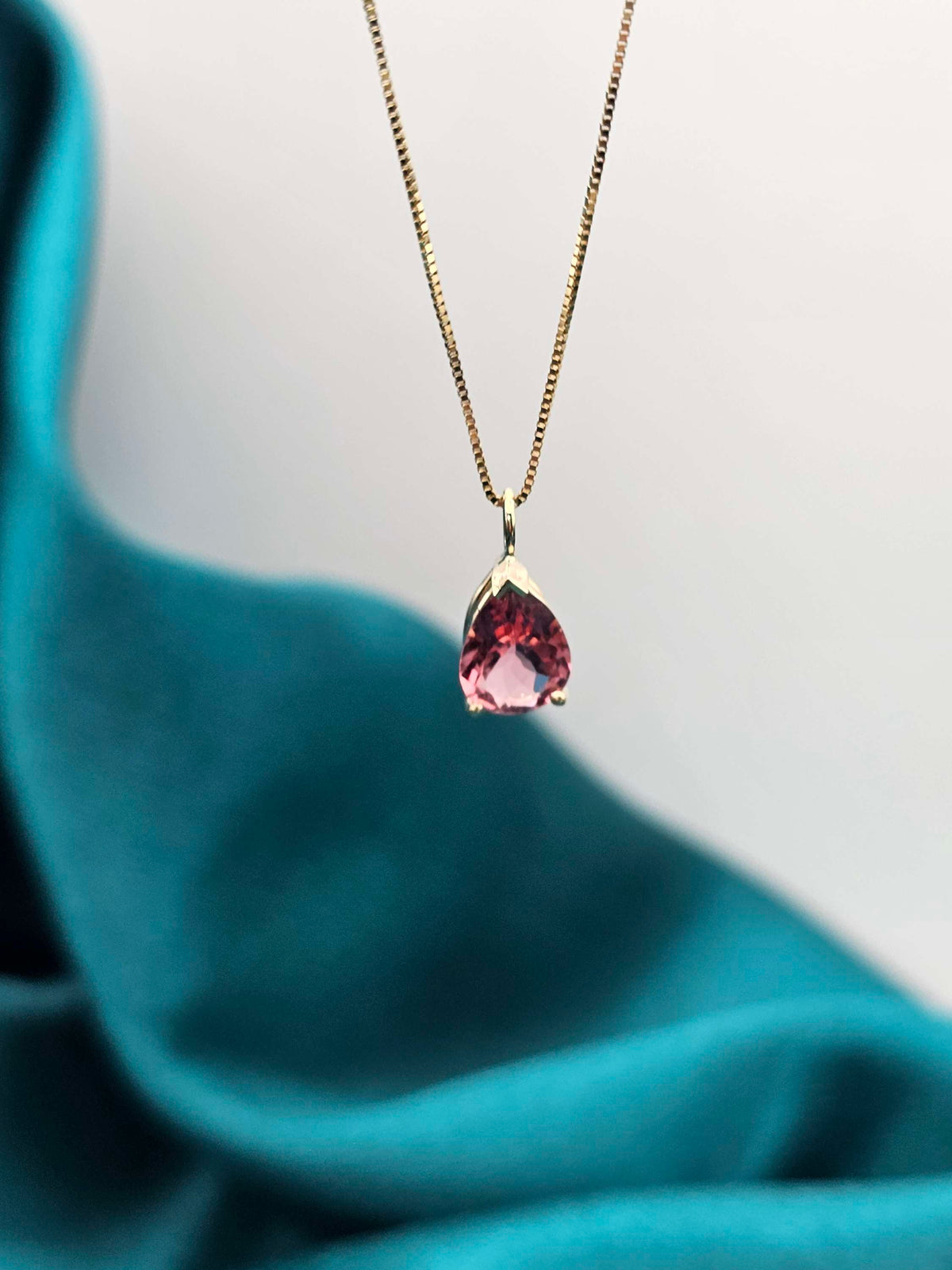 Pear shape Pink tourmaline pendant in 14k yellow gold.