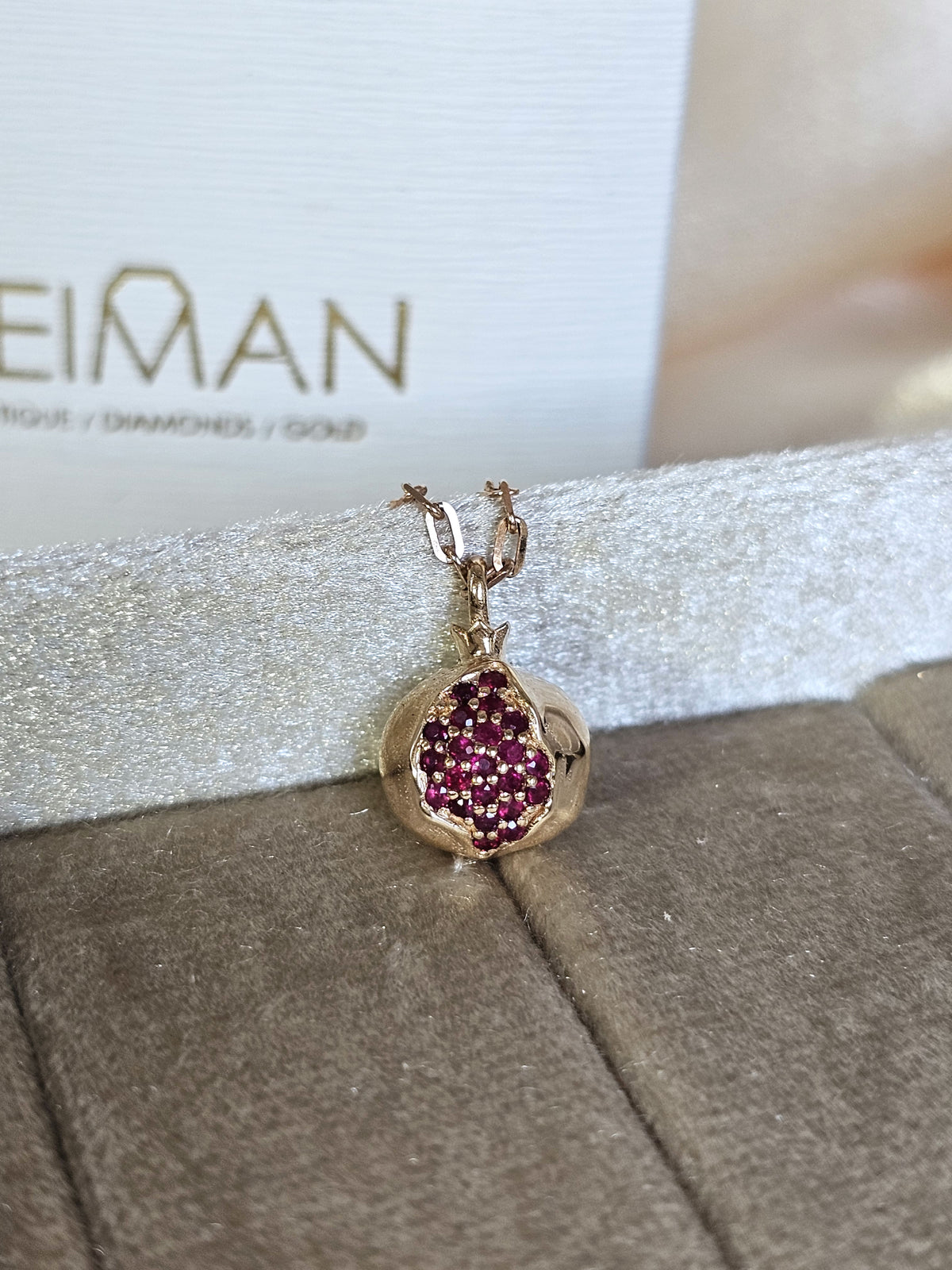 Baby pomegranate pendant 14k gold set with natural ruby's without a chain.