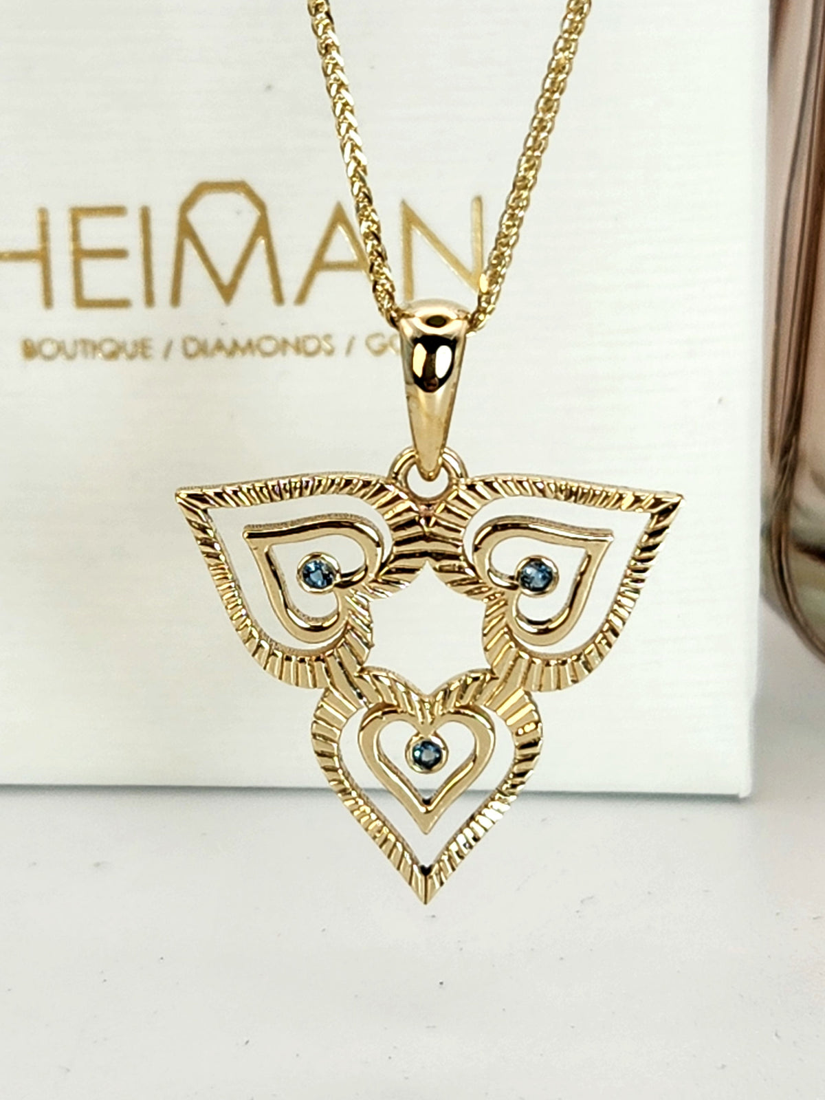 heart necklace 14k gold set with blue topaz comes on a 14k yellow chain