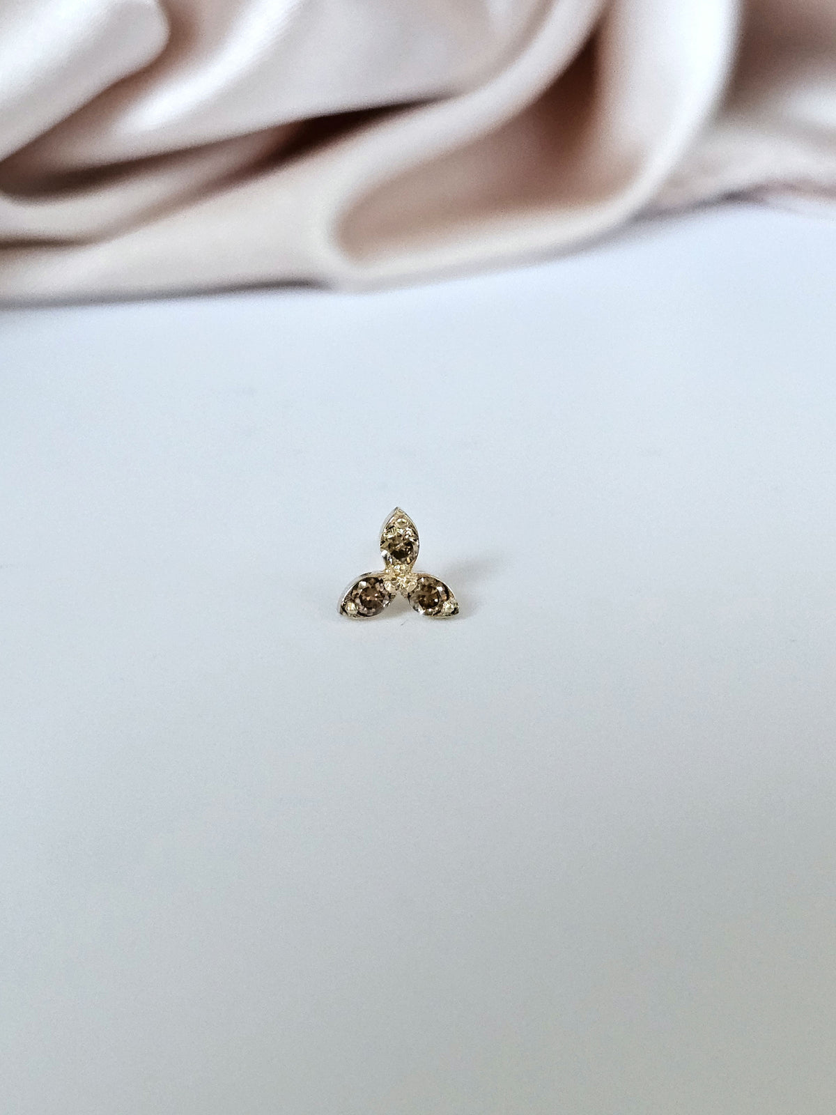 Single three stone stud earring, 14k gold set with natural congac diamonds.
