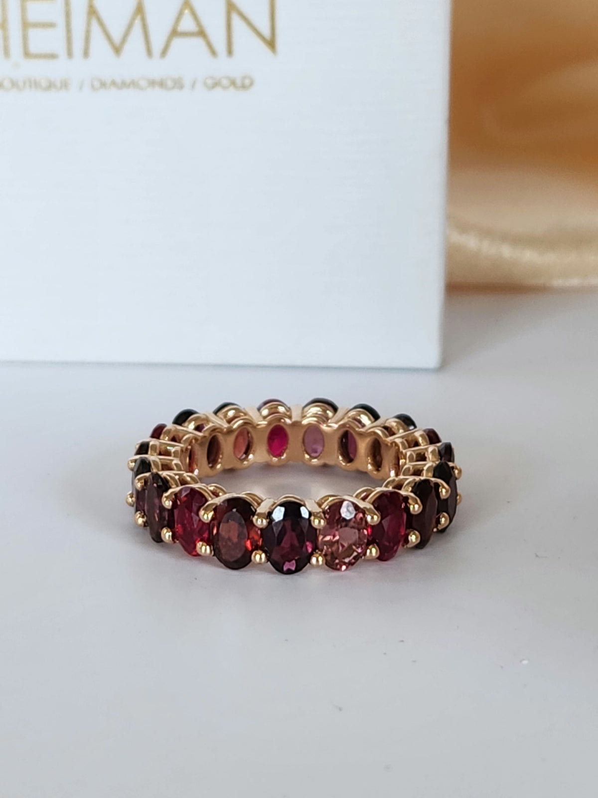 The "Red dream" ring. 14k rose gold infinity ring set with lab garn, tourmaline