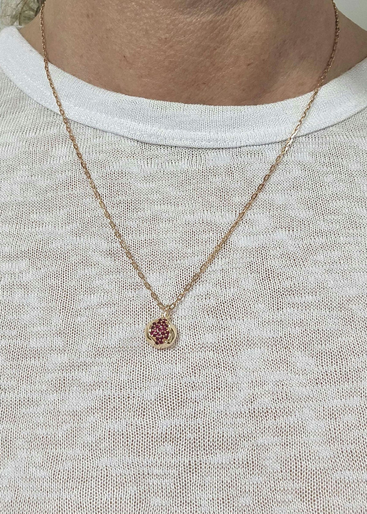 Baby pomegranate pendant 14k gold set with natural ruby's without a chain.
