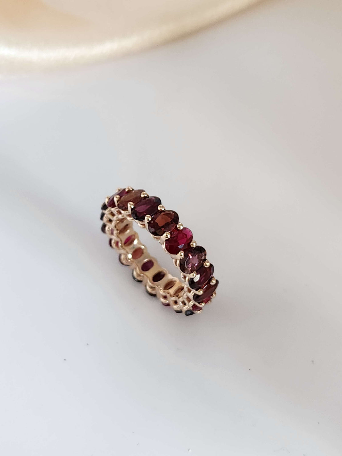 The "Red dream" ring. 14k rose gold infinity ring set with lab garn, tourmaline