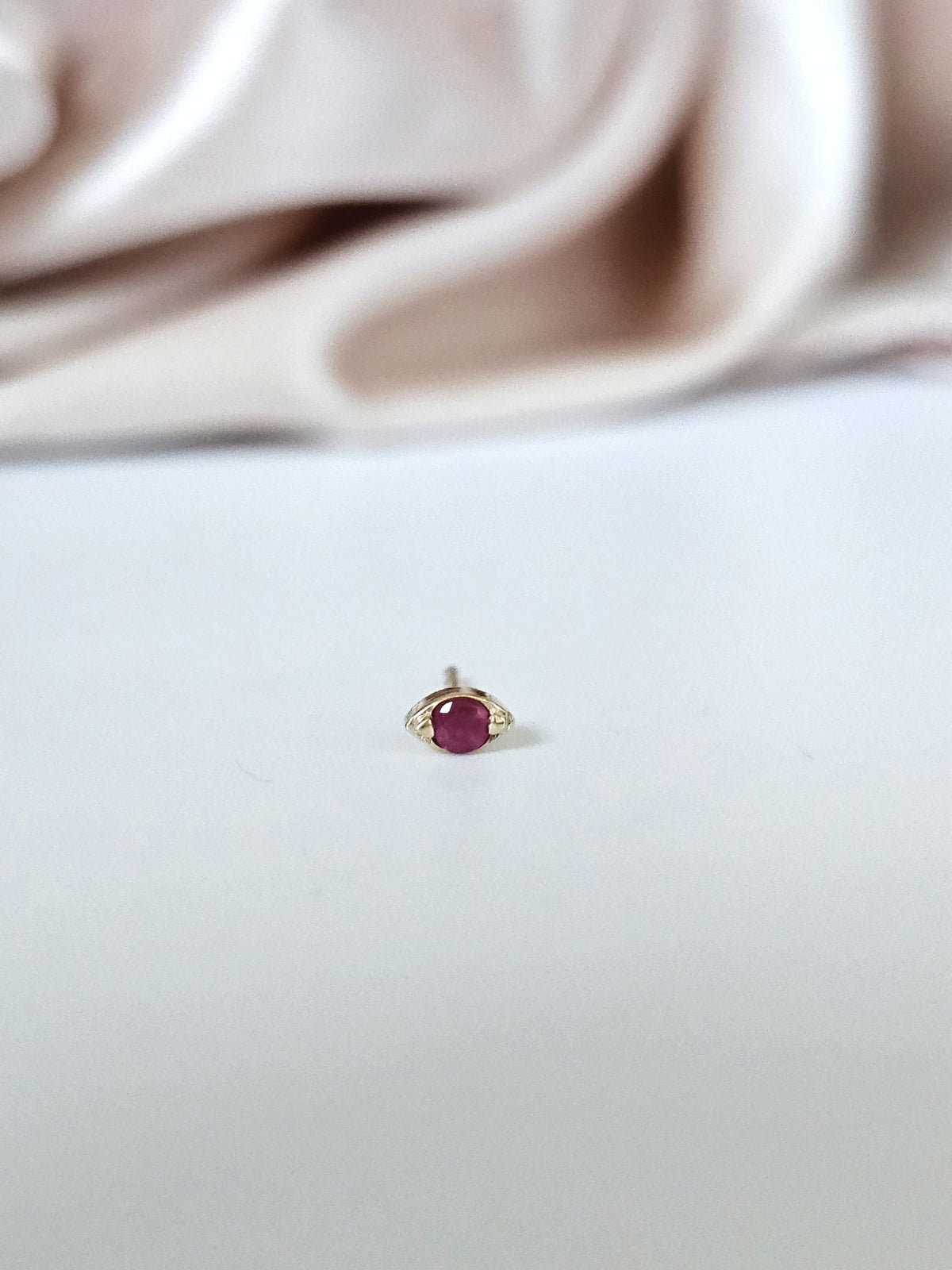 Single earring, 14k gold set with natural ruby.