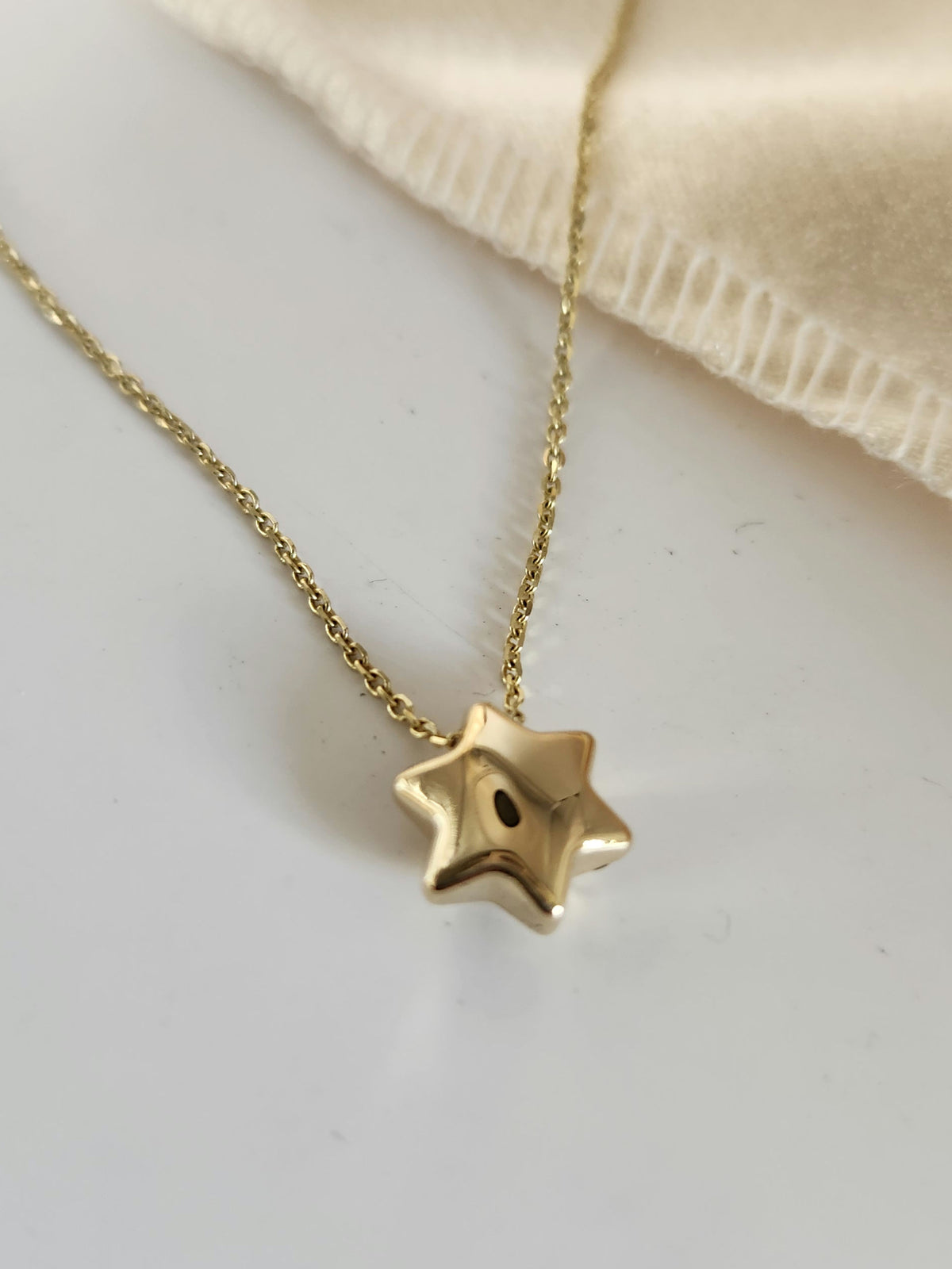 Bubble Star david necklace comes on 18 inch 14k chain.