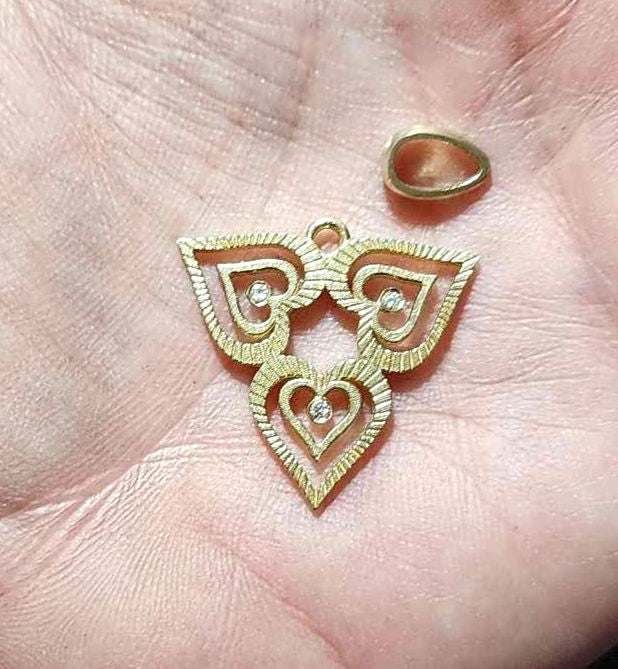 Triple heart pendant set with natural diamonds
