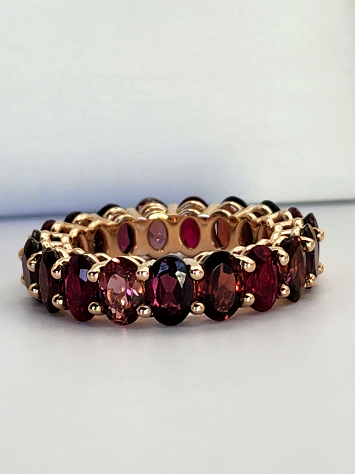 The "Red dream" ring. 14k rose gold infinity ring set with lab garn, tourmaline