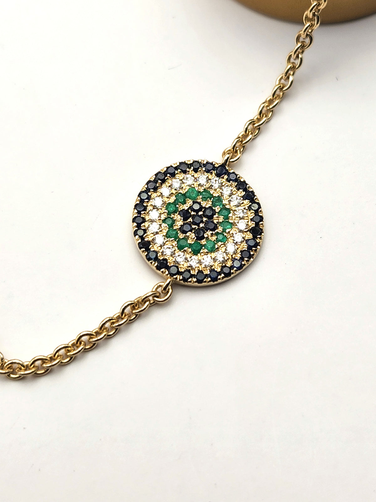 Eye bracelet made from 14k gold set with diamonds ,Sapphires, and Emerald.