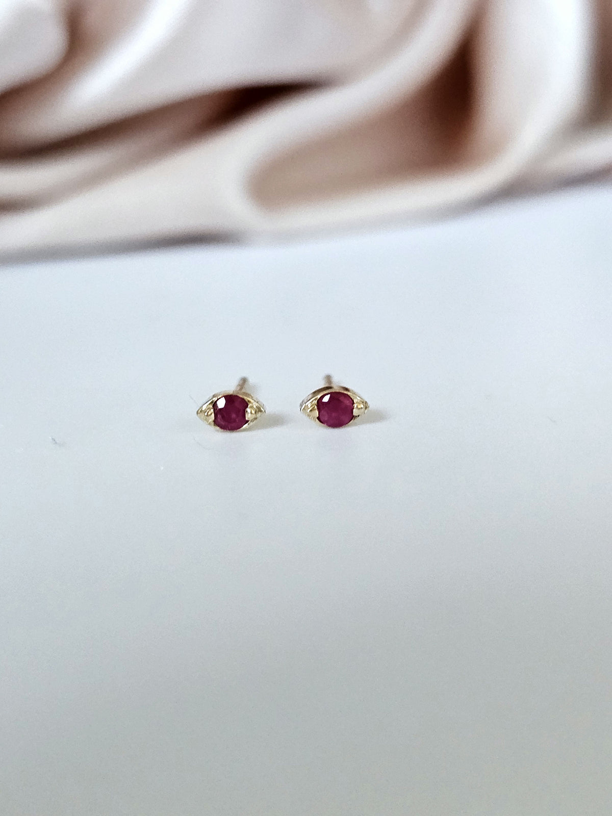 Pair of 14k gold single ruby earrings