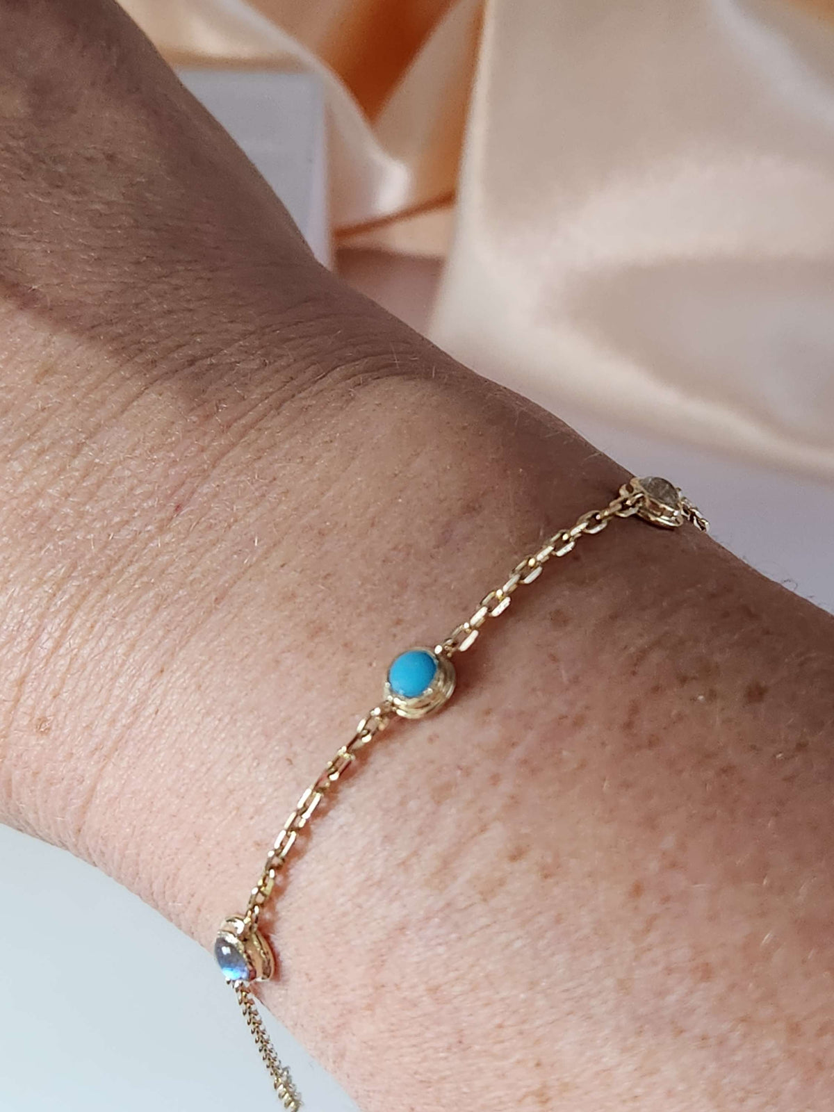 Gold eye bracelet set with natural gems.