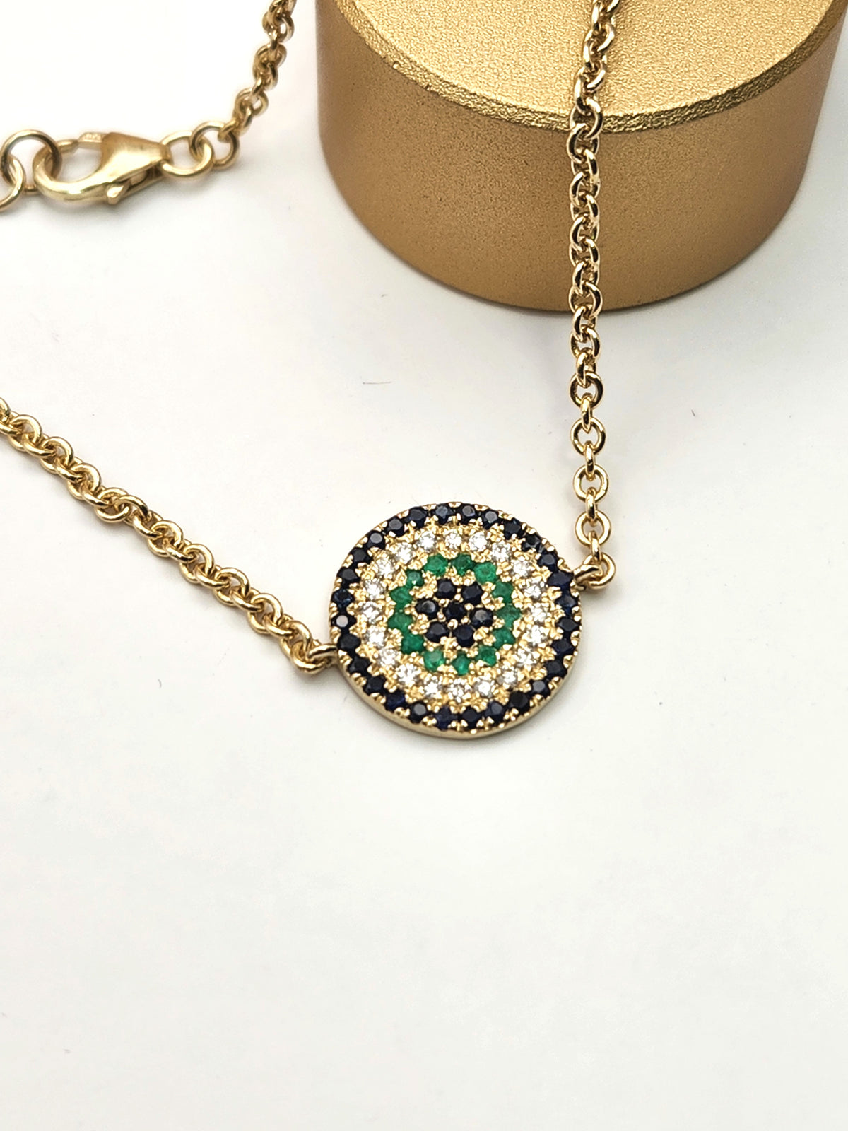 Eye bracelet made from 14k gold set with diamonds ,Sapphires, and Emerald.