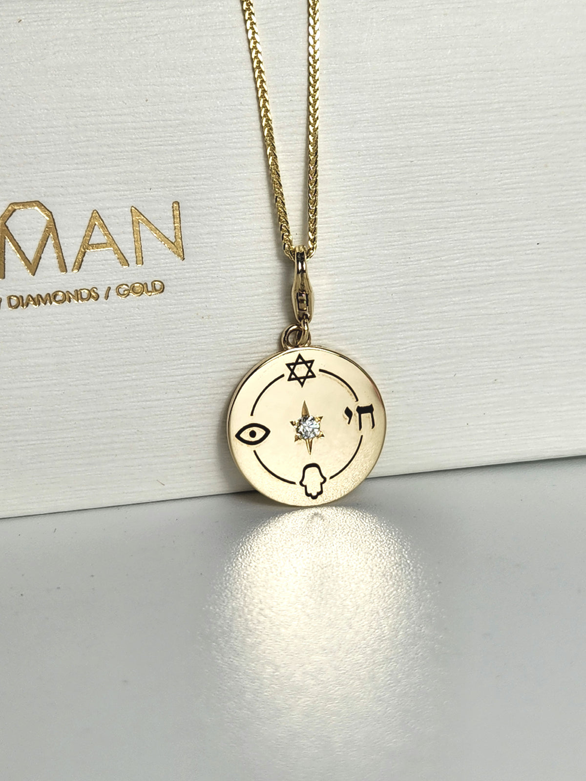 Medium size "Jewish compas" necklace, 14k gold set with a natural diamond.