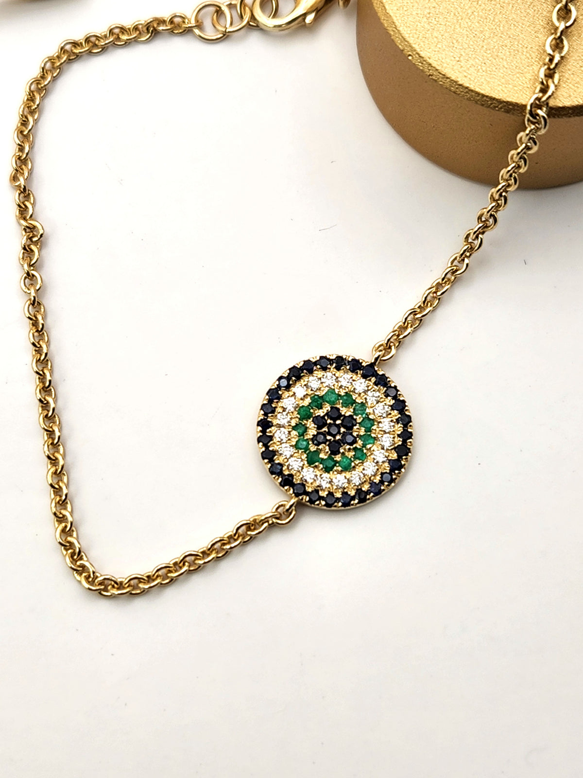 Eye bracelet made from 14k gold set with diamonds ,Sapphires, and Emerald.