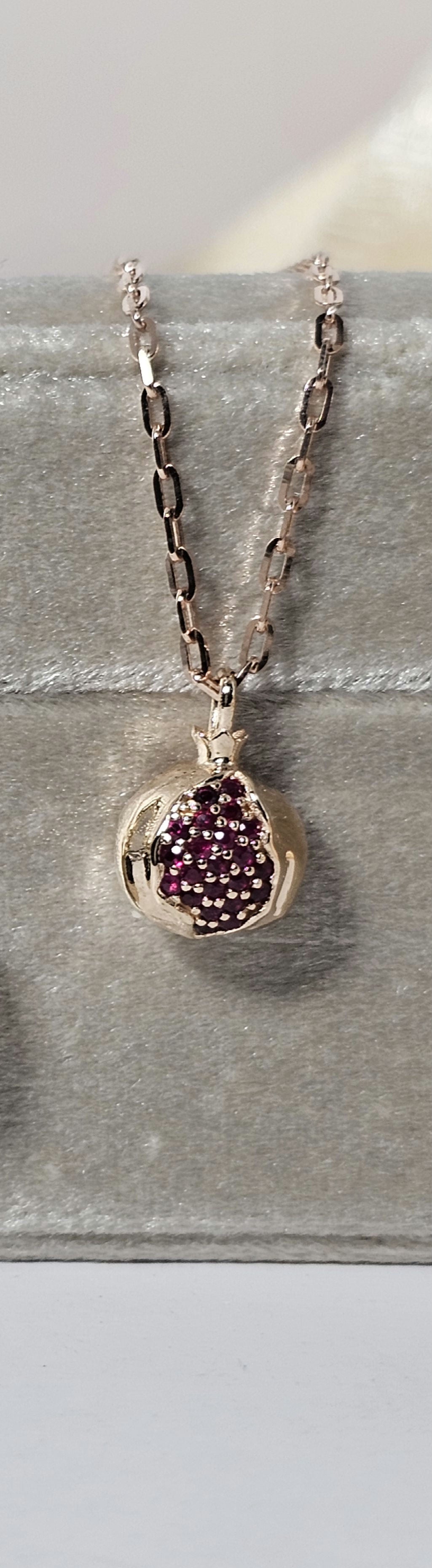 Baby pomegranate pendant 14k gold set with natural ruby's without a chain.