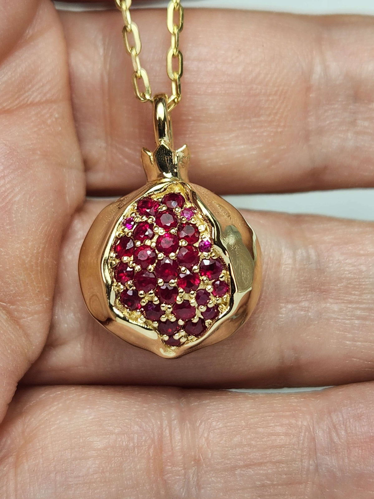Large 20mm pomegranate in 14k gold set with natural ruby's