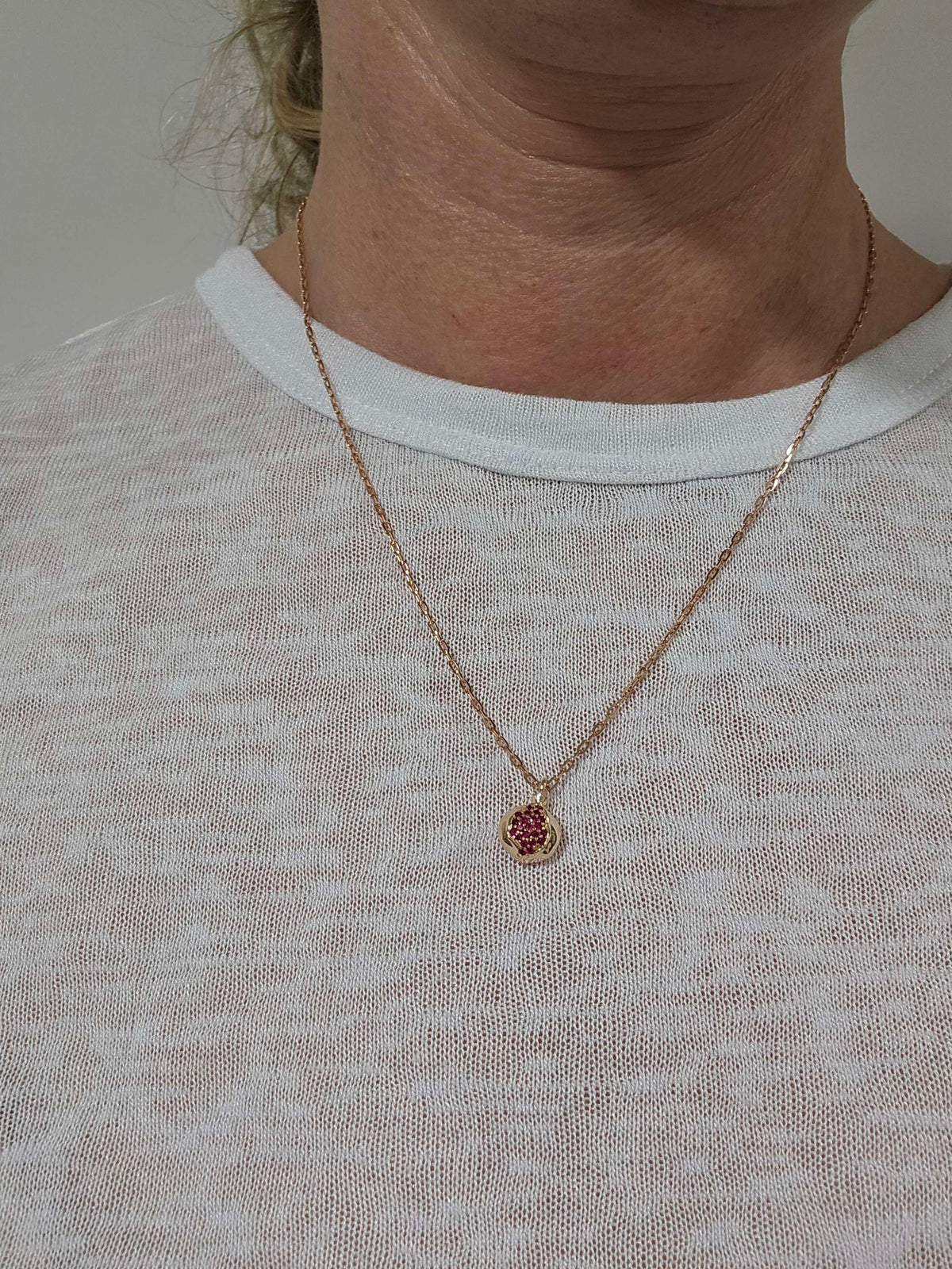 Baby pomegranate pendant 14k gold set with natural ruby's without a chain.