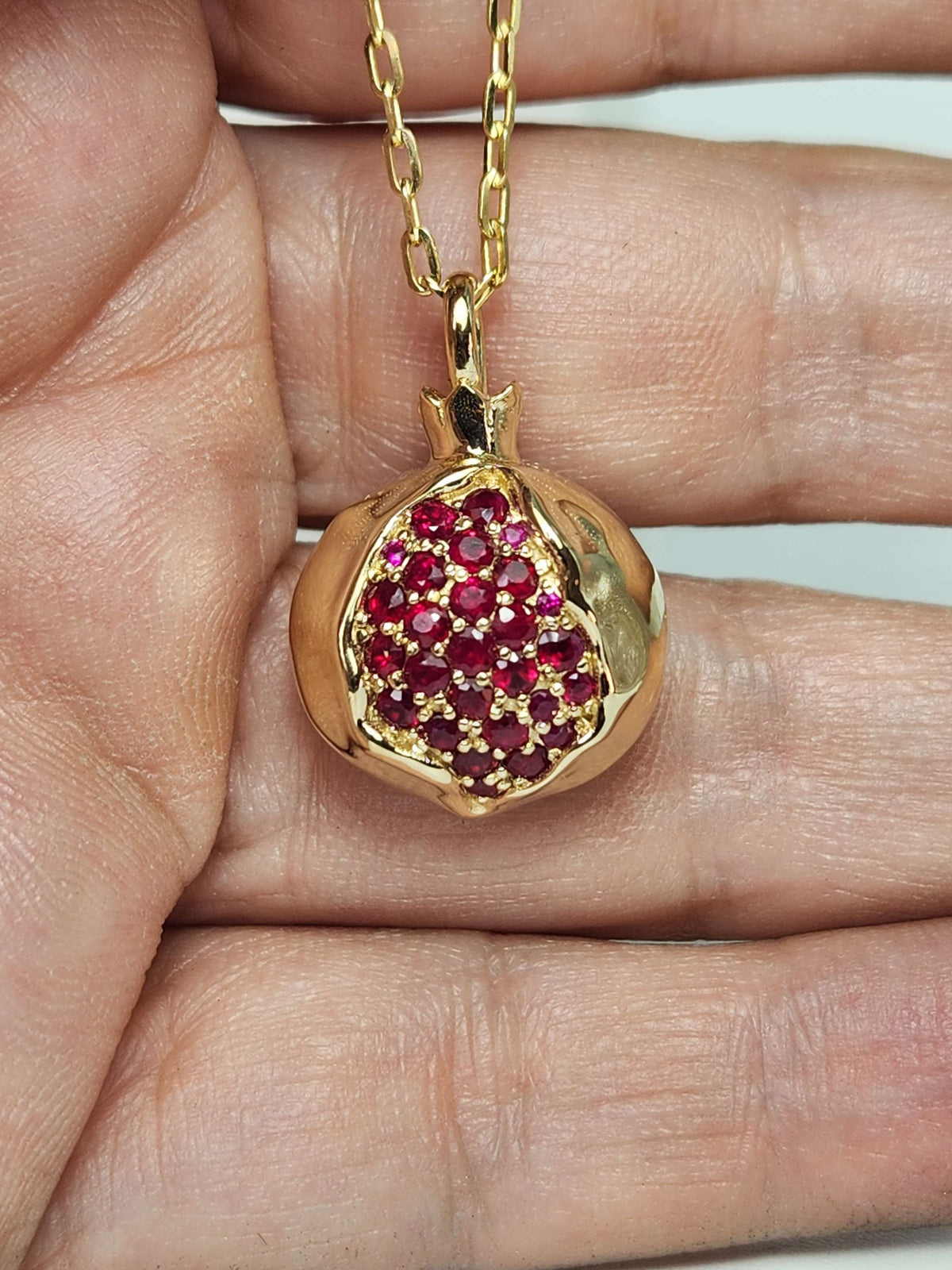 Large 20mm pomegranate in 14k gold set with natural ruby's