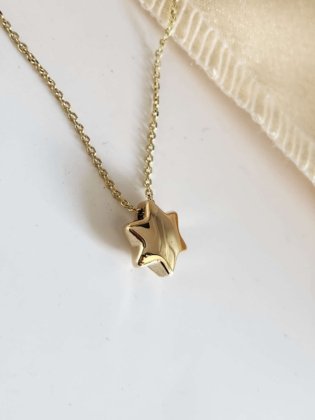 Bubble Star david necklace comes on 18 inch 14k chain.